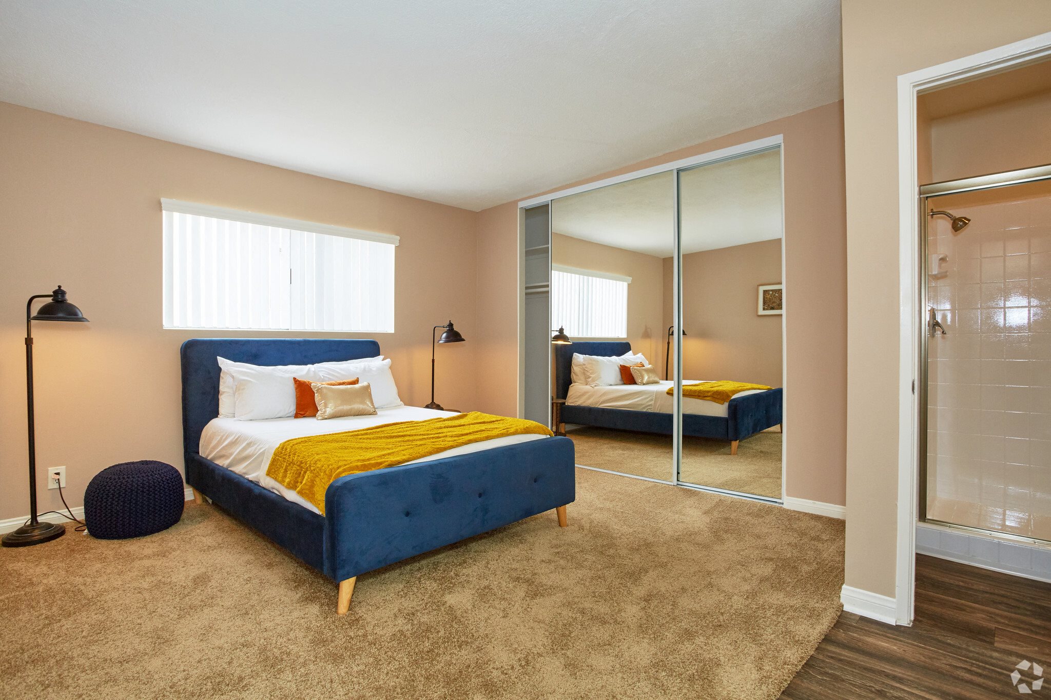 a bedroom with a bed and a mirror